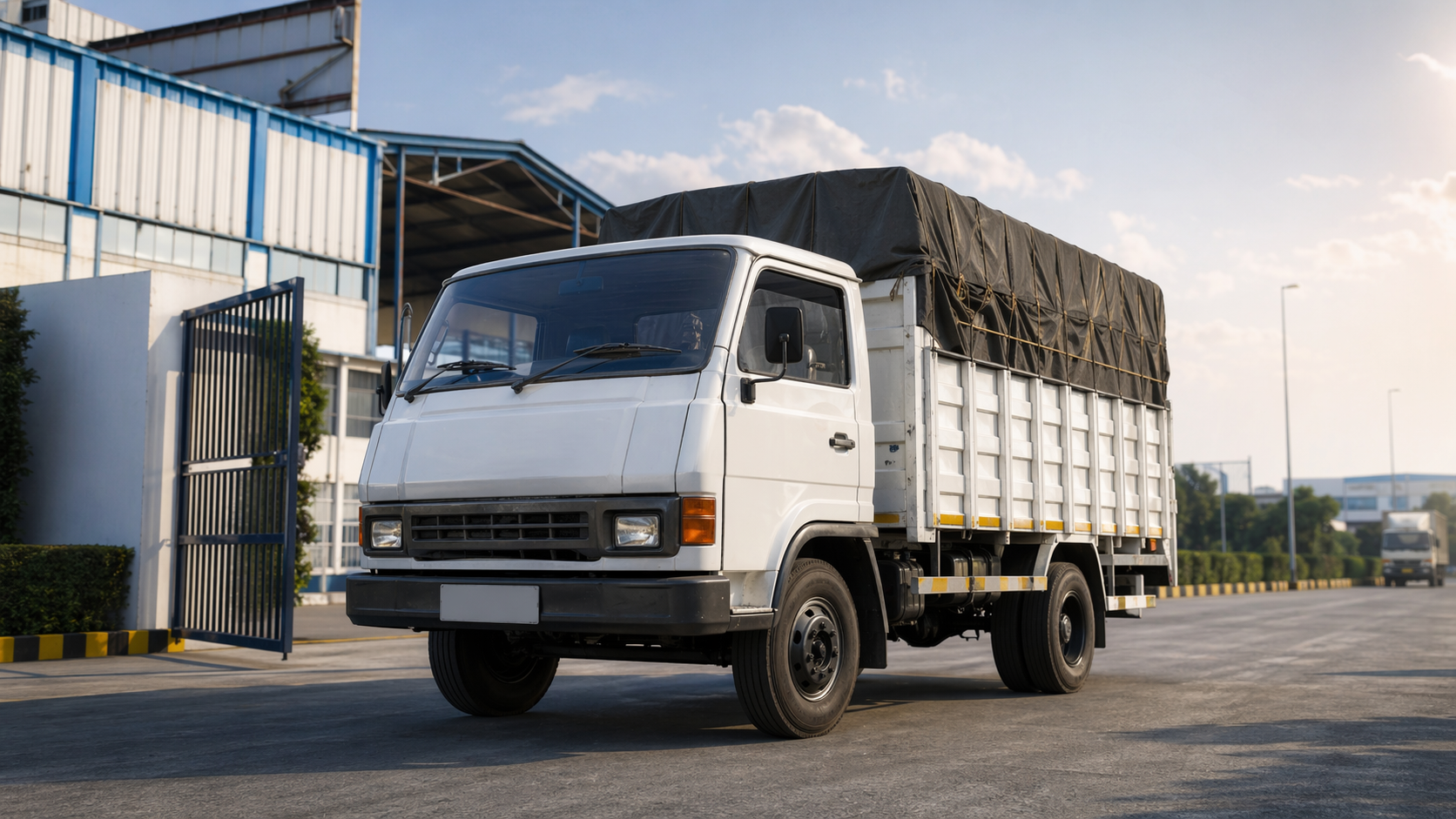 TATA 407 cargo truck outside a logistics warehouse